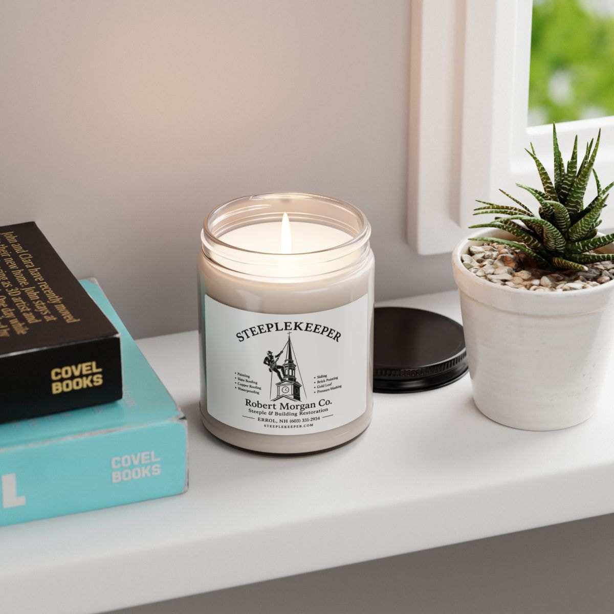 Steeplekeeper branded candle with Robert Morgan Co. label styled on a windowsill